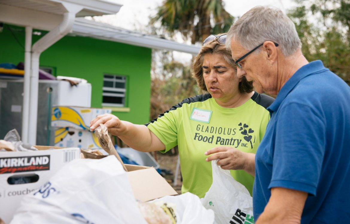 Miriam Ortiz, founder and director of the Gladiolus Food Pantry, a Harry Chapin Food Bank partner agency, works at a distribution in the wake of Hurricane Ian.