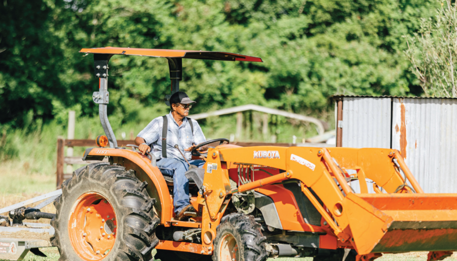 A farmer is pictured on large orange machinery